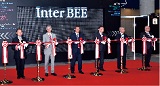 Representatives from the MIC and METI take part in the tape-cutting ceremony as guests of honor