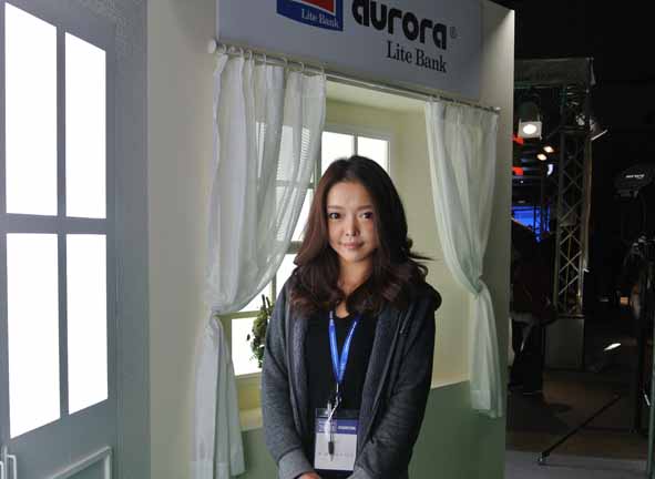 Ms. Hayashi at the Aurora Lite Bank booth.